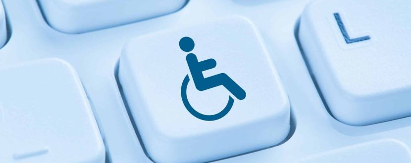 A blue wheelchair accessibility symbol appears on a single keyboard key among surrounding white keys.