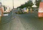 A completely wrecked car that is being attended to by firemen in June 1989 that Clive, Jess and their friends were in