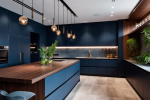 A Modern minimalist kitchen with stainless steel appliances and a dark blue backsplash