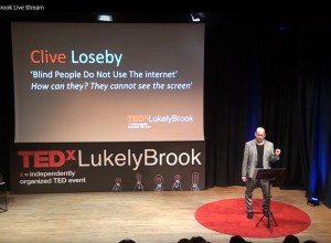 Clive Loseby on the TEDx Stage delivering his talk on website accessibility