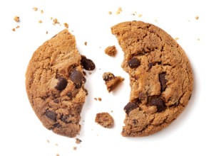 Chocolate chip cookie with crumbs isolated on white background