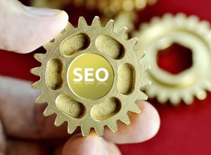 Person holding cogs spelling SEO