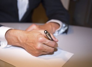 Business man writing on paper in an office