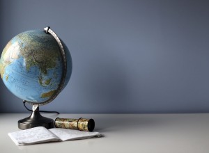 Globe and exercise book on the white student's desk