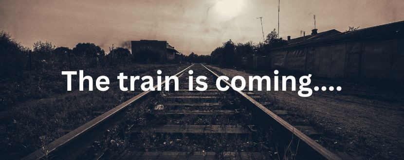 A sepia photo of a set of railway tracks. The words A train is coming is displayed over the front of it.