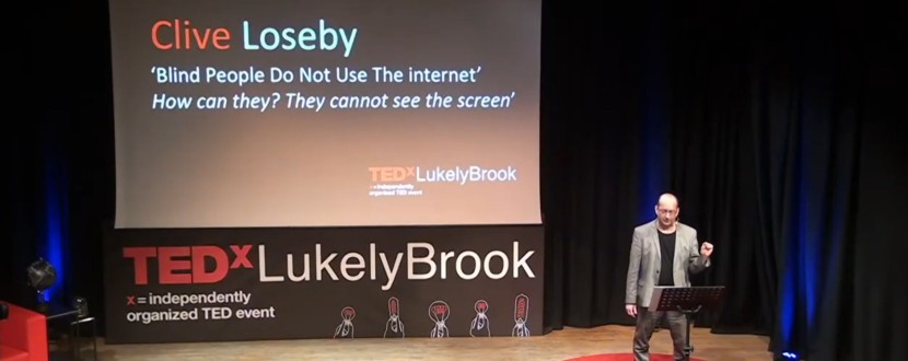 Clive Loseby on the TEDx Stage delivering his talk on website accessibility