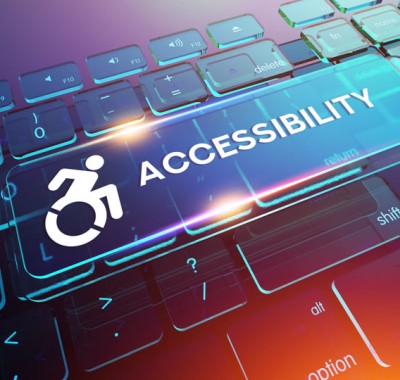 A computer keyboard with a glowing \ACCESSIBILITY\ key. The key features an accessibility icon of a person in a wheelchair. The background is a blend of blue, purple, and pink hues, creating a modern and vibrant look.