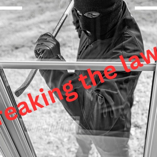 A man wearing a balaclava is trying to break into a house using a crowbar. Text reads Breaking the law!