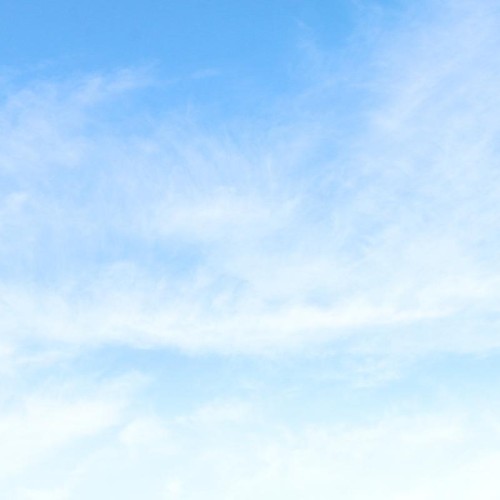 A blue sky with wisps of cloud