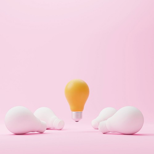 A lit lightbulb, floating in the air. 4 unlit lightbulbs lie on the floor below it