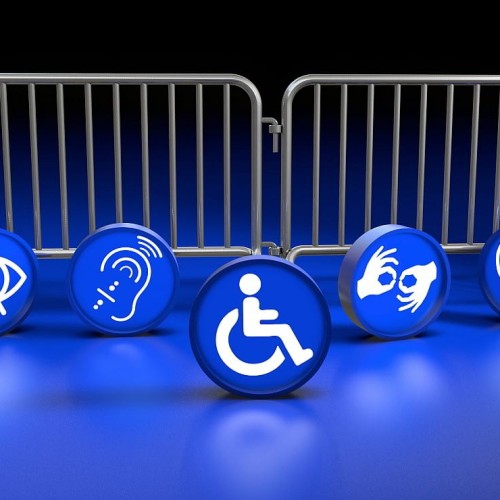 Blue icons representing different types of disabilities placed in front of metal barriers to illustrate the hidden obstacles people face online