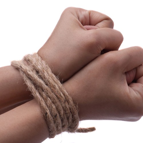 Female hands, her wrisits are tied with rope