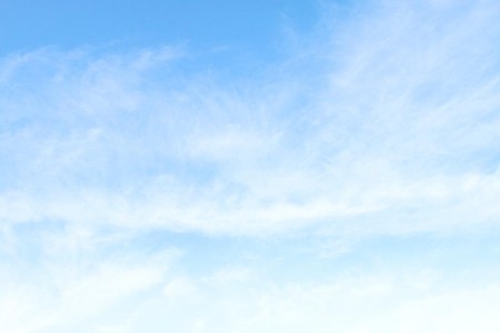 A blue sky with wisps of cloud