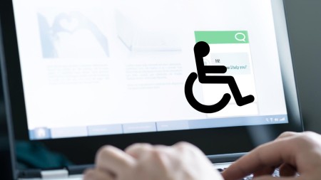 Close-up of hands typing on a laptop keyboard. On the screen, a chat window with Hi! How can I help you? is visible. A large icon of a person using a wheelchair is overlaid on the screen.