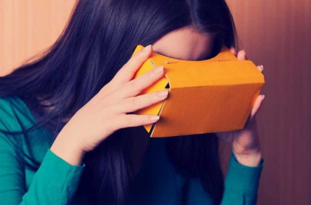 Woman looking into a cardboard 3D viewer