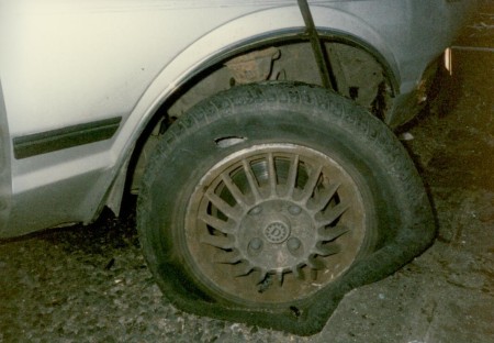 A close-up of the blown-out car tyre and the kerb that was hit by the car in June 1989 that Clive, Jess and their friends were in