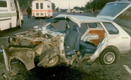 An estate car that has been very badly damaged in an accident