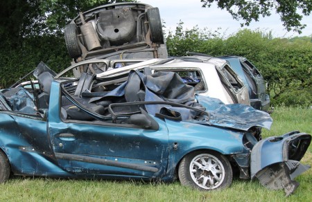 A Collection of Wrecked Cars in a Countryside Field.