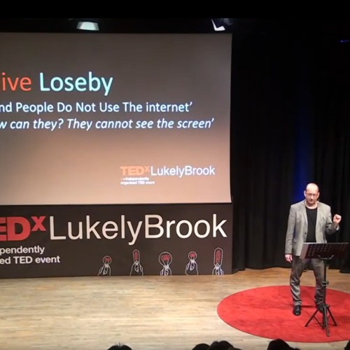 Clive Loseby on the TEDx Stage delivering his talk on website accessibility
