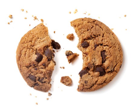 Chocolate chip cookie with crumbs isolated on white background