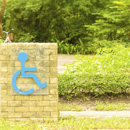 Wheelchair sign against green nature background