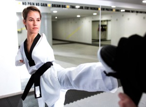 Young woman without arms training hard in martial arts