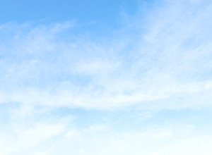 A blue sky with wisps of cloud