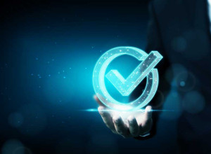 An illuminated neon sign of a blue tick in a circle