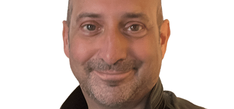 Clive Loseby, a passionate advocate for access for web and inclusive design, has brown eyes, no hair, has shaped stubble and is smiling