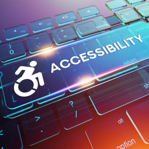 A computer keyboard with a glowing ACCESSIBILITY key. The key features an accessibility icon of a person in a wheelchair. The background is a blend of blue, purple, and pink hues, creating a modern and vibrant look.
