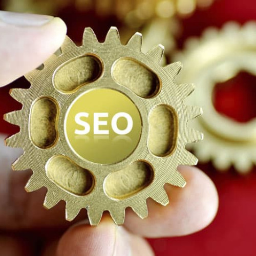 Person holding cogs spelling SEO