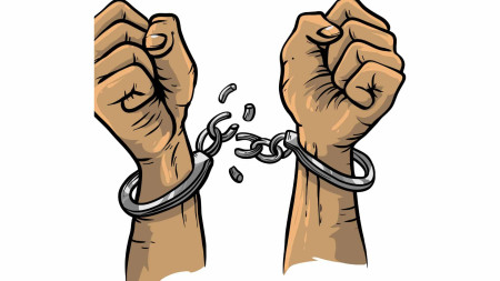 Two clenched fists, pointing upwards, in handcuffs that have been broken apart