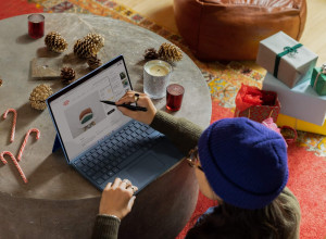 Girl using a touch pen on her laptop's screen